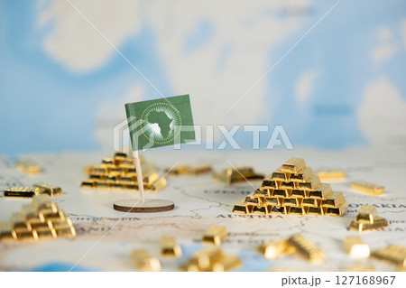 African Union flag displayed on a world map with gold bars, symbolizing the continent's vast resources, economic development, global trade potential, and copy space African Union flag displayed on a world map with gold bars, symbolizing the continent's vast resources, economic development, global trade potential, and copy space 127168967