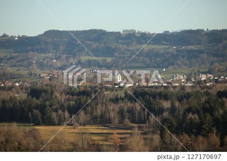 Rural landscape with a small town in the distance Rural landscape with a small town in the distance 127170697