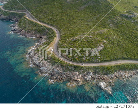 Aerial view car Roadtrip Winding road along rocky coast of Cap Corse peninsula on Corsica island France Aerial view car Roadtrip Winding road along rocky coast of Cap Corse peninsula on Corsica island France 127171078