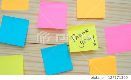 Colorful sticky notes on a wooden background with one yellow note saying Thank you. Ideal for gratitude, teamwork, communication, or motivational concepts. Colorful sticky notes on a wooden background with one yellow note saying Thank you. Ideal for gratitude, teamwork, communication, or motivational concepts. 127171399
