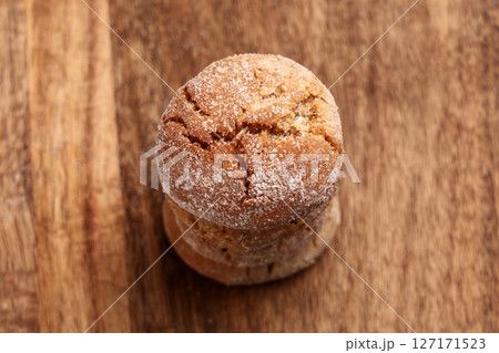Stack of festive baked ginger snap cookies on wooden table close up 127171523