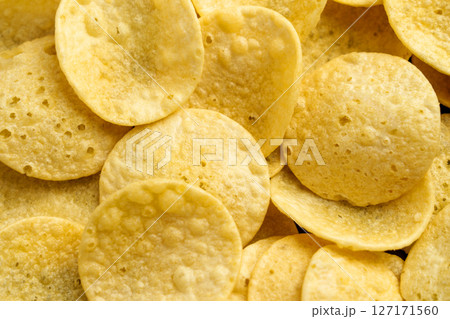Fresh crispy potato chips. Junk food product. Close up 127171560