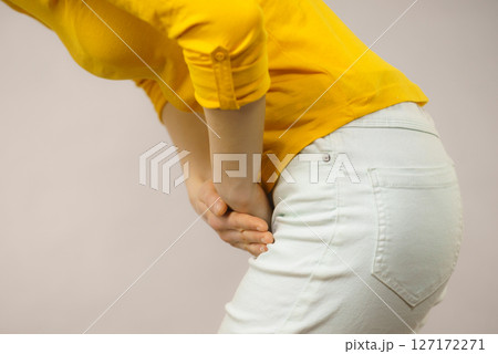 Woman with hands holding her crotch Woman with hands holding her crotch 127172271