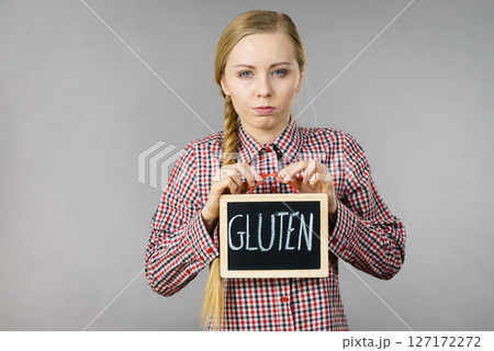 Woman holding board with gluten sign Woman holding board with gluten sign 127172272