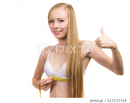 Girl measuring her chest under breast Girl measuring her chest under breast 127172316
