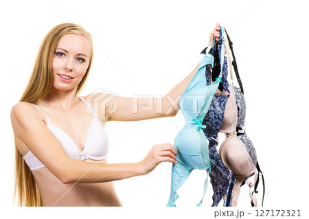 Woman holds bras, choosing 127172321