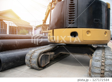 Rear view of a mini excavator in operation 127172584