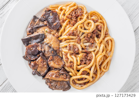 Unagi udon noodles served with beef and crispy garlic thyme shiitake 127173429