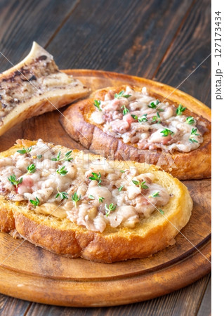 Toasted marrow sandwiches garnished with thyme served on crusty golden bread slices 127173434