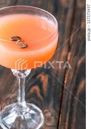 Guayaba Arabica cocktail blends guava, coffee, and rum in moody coupe glass Guayaba Arabica cocktail blends guava, coffee, and rum in moody coupe glass 127173437