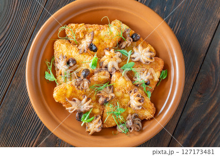 Golden Potato Rosti With Baby Octopuses And Fresh Pea Shoots Garnished Delicately 127173481