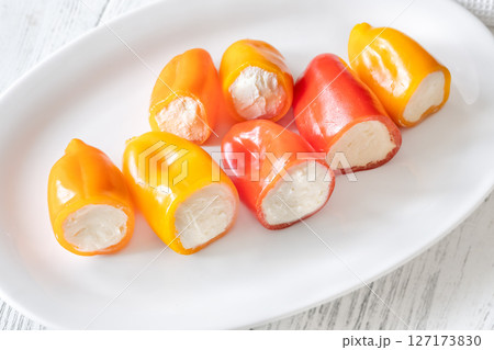 Colorful Baby Bell Peppers Stuffed With Cream Cheese on White Plate Colorful Baby Bell Peppers Stuffed With Cream Cheese on White Plate 127173830