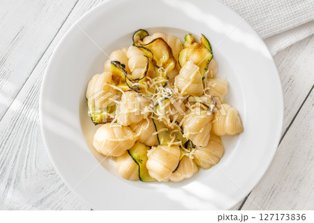 Conchiglioni Pasta with Zucchini and Parmesan Served on Clean White Porcelain Plate Conchiglioni Pasta with Zucchini and Parmesan Served on Clean White Porcelain Plate 127173836