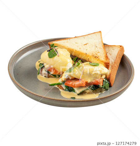Portion of eggs benedict with bread and salmon 127174279