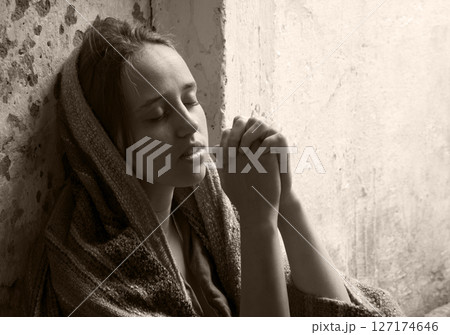 Poor young girl prayint to God 127174646
