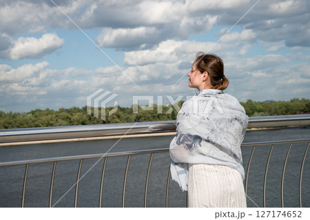 Young girl looking to the sky 127174652