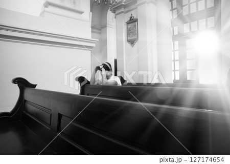 Girl sitting in the church Girl sitting in the church 127174654