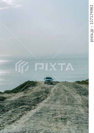White Car on Coastal Cliff Road White Car on Coastal Cliff Road 127174962