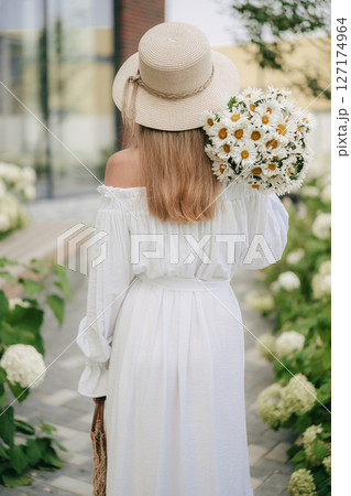 Girl with a Bouquet of Daisies in the Garden Girl with a Bouquet of Daisies in the Garden 127174964