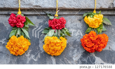 Vibrant Red Orange Yellow Marigold Flower Bouquets Hanging Stone Wall life vivid image photo still 127176588