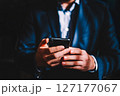 Business man with mobile phone in hands, close up view. Businessman in suit holding cell phone 127177067