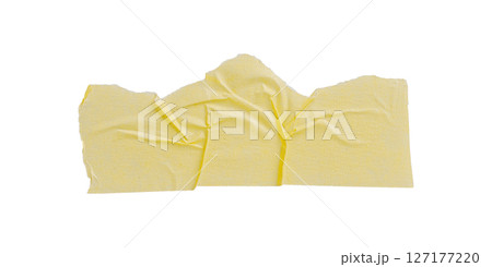 Yellow painter's tape isolated on white background, macro. Torn, crumpled, twisted strips of yellow painter's tape on white background 127177220