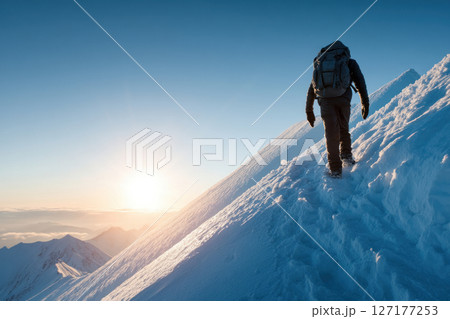 Hiking adventure on snowy mountain peak at sunrise outdoor exploration scenic viewpoint 127177253