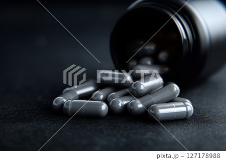 Spilled capsules reflecting improper disposal of pharmaceutical waste 127178988