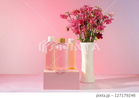 Wellness composition with rose water and fresh columbine and aquilegia flowers, spa salon advertising card, natural self-care and healthy lifestyle concept, abstract composition with flowers. Wellness composition with rose water and fresh columbine and aquilegia flowers, spa salon advertising card, natural self-care and healthy lifestyle concept, abstract composition with flowers. 127179246
