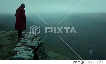 Solitary Figure in Red Coat Contemplates Misty Landscape Over Ro 127181344