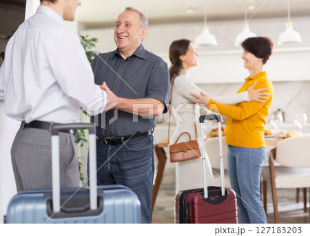 Parents joyfully welcome their adult children who have come to visit from far away 127183203