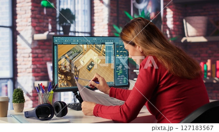 Remote worker in creative office uses CAD software and blueprints plan, design a house interior and provides a user interface for virtual home customization. Detailed architectural layout. Camera A. Remote worker in creative office uses CAD software and blueprints plan, design a house interior and provides a user interface for virtual home customization. Detailed architectural layout. Camera A. 127183567