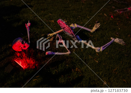 Creepy Skeleton Scene with Pink Lighting in Spooky Halloween Display 127183730