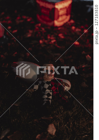 Haunted Carnival Yard with Scary Clowns and Halloween Decorations 127183810