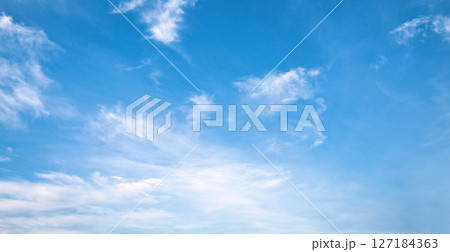 sky is blue and clear with clouds 127184363