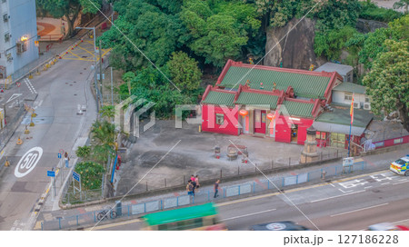 June 6 2025 Traditional Red Temple by Street with Lush Green Trees 127186228