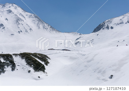 4月の春、青空の下に堂々と広がる真っ白な立山連峰の雄大な雪景色。 4月の春、青空の下に堂々と広がる真っ白な立山連峰の雄大な雪景色。 127187410