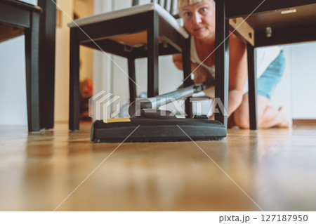 Vacuuming a parquet floor Vacuuming a parquet floor 127187950