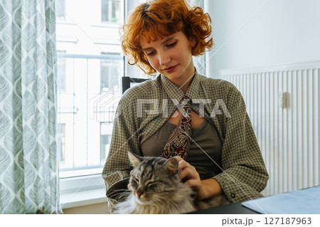 Portrait teenage girl with red hair and pet cat at home Portrait teenage girl with red hair and pet cat at home 127187963