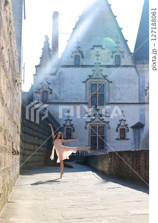Ballerina dancing in soft light by French castle architecture Ballerina dancing in soft light by French castle architecture 127188061