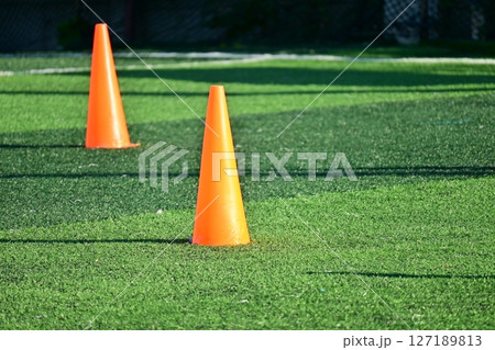 artificial green grass soccer field with orange training cones 127189813