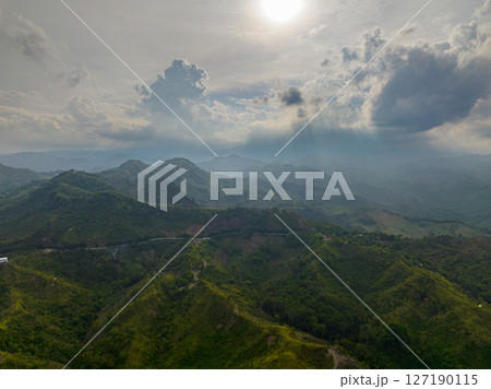 Drone view of cloudy mountain with lush foliage and green mountain hills. Mindanao, Philippines. 127190115