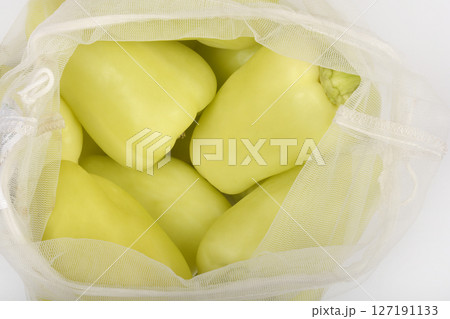 Reusable mesh bag filled with bell peppers 127191133
