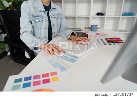 Graphic UI designer work on computer laptop and with graphic, working after brainstorming unique design with professional developer UX team 127191734