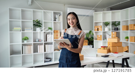 Entrepreneur startup business woman sme holding tablet. Small Online Business Owner, Online Marketing and Product Packing and Delivery Service. E-commerce concept 127191785