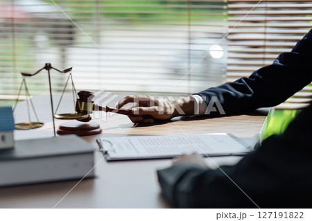 Close up lawyer hands holding pen, signing in white paper form or application to confirm and deal contract agreement 127191822