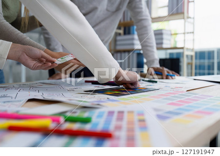 UI designer and UX developer brainstorm idea to design the application appearance in the early stage. Creative digital development agency. UX UI concept 127191947