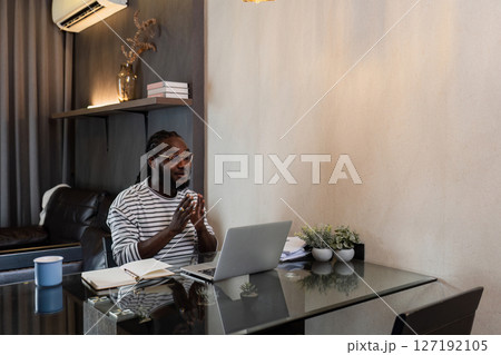 Young African American business man working with laptop and document on desk at home. work from home concept 127192105