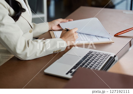 Lawyer sign client document sent to the law firm and work on laptop. lawyer concept 127192111