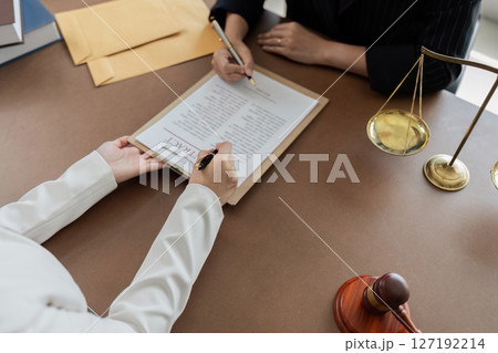 Hand of lawyer pointing at document agreement, contract for businessperson, client signing contract Hand of lawyer pointing at document agreement, contract for businessperson, client signing contract 127192214